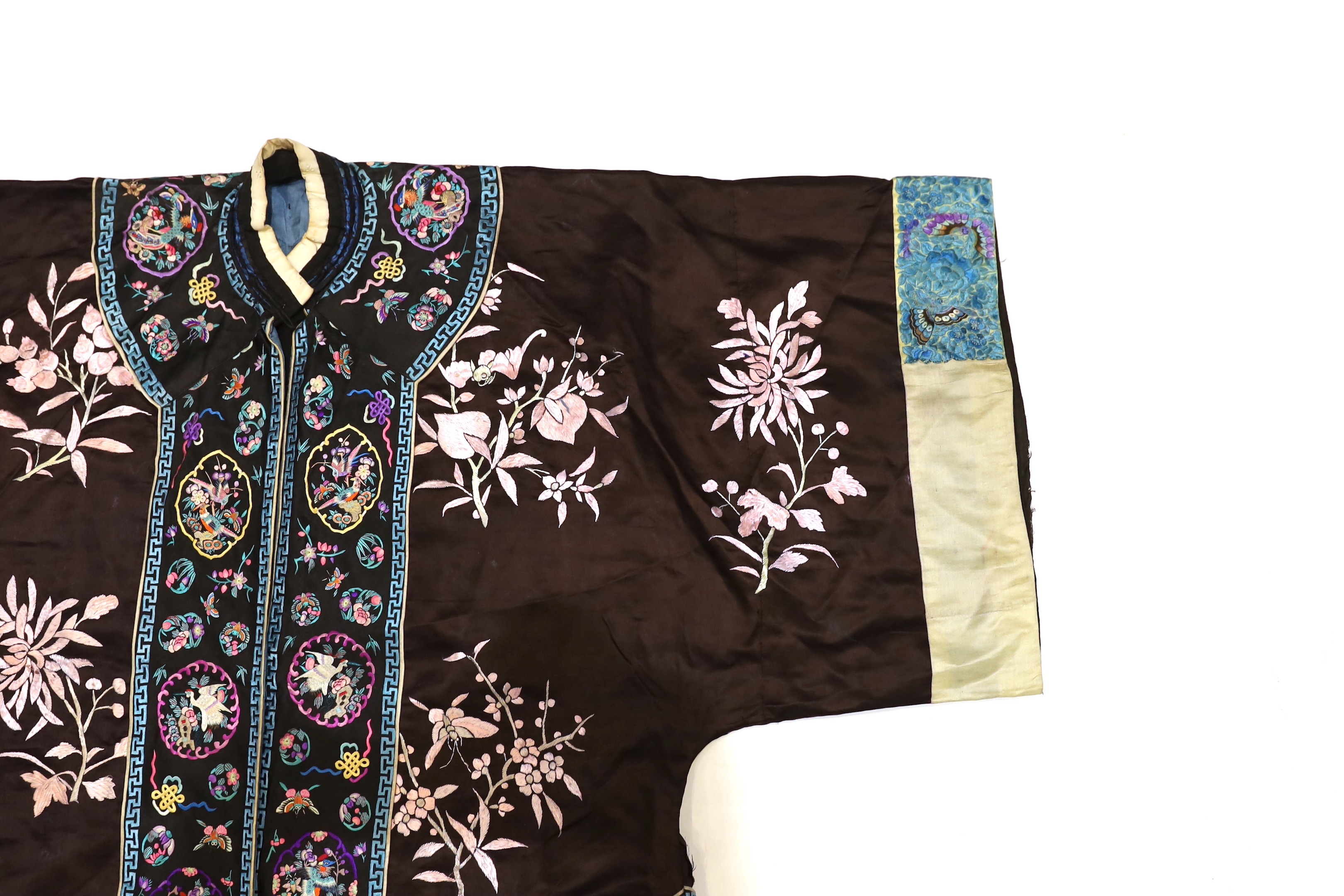 A Chinese early Republic blue silk embroidered robe with colourful ornately embroidered sleeve bands and borders to the robe